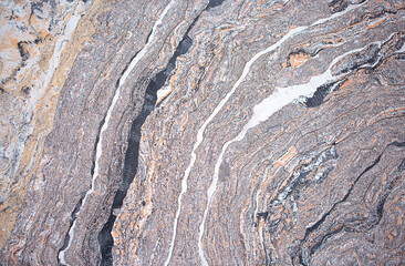 Gray background of decorative plaster with abstract spots. Unusual silver wall texture with beautiful patterns, creative surface background. Dressing coating for building cladding.