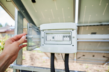 Professional worker's point of view on configuring solar panel. Male turning on new photovoltaic...