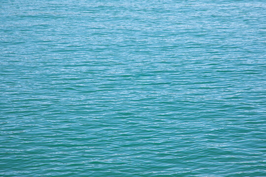 sea water background in light blue wavelets for wallpaper