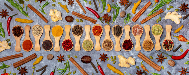 A set of spices on a gray background. Variety of spices from India. Food decoration design. Various...