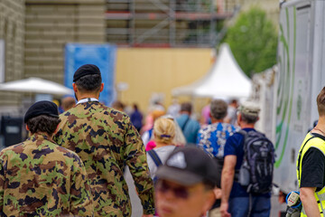 Swiss Army soldiers at town square of Federal Palace on a cloudy summer day. Photo taken July 1st, 2023, Bern, Switzerland.