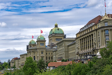 Obraz premium Towers with green copper domes of Swiss Federal Palace on a cloudy summer day at Bern, Capital of Switzerland. Photo taken July 1st, 2023, Bern, Switzerland.