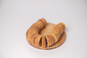 Figs or dried figs on white bowl with white background, Figs or dried figs arranged in round shaped on the white background in a wooden bowl. The fig is the edible fruit of Ficus Carica