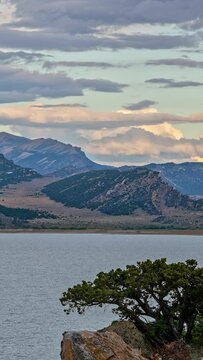 Vertical Looking across Flaming Gorge towards Richard's Mountain in timelapse as clouds move through the sky.