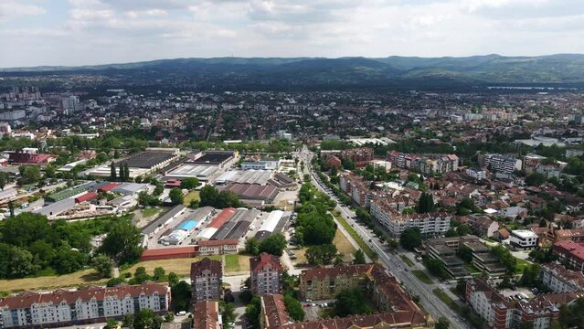 Aerial footage of city Novi Sad and mountain Fruska gora in the background in Serbia