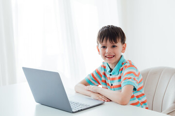 Boy doing learning task at school on computer