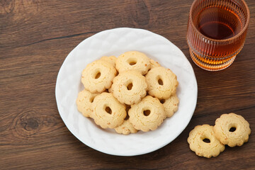Kue Keju or Cheese cookies. Served on white plate
