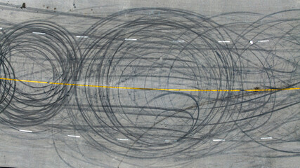 Aerial view tire track mark on asphalt tarmac road race track texture and background, Abstract background black tire track skid on asphalt road, Tire mark skid mark on asphalt road.