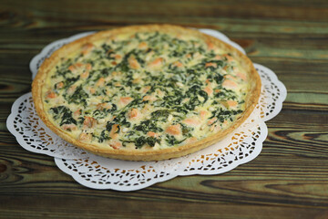 Delicious Quiche pie with salmon fish and pine nuts filling