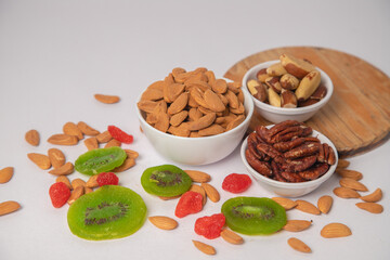 Mixed nuts on white bowl with white background, mixed dry fruits and nuts on white bowl with white background