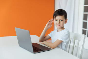 Little boy using laptop on background