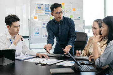 Group of Asian business people, teamwork, people and crisis concept - business team sitting sad and solving problems in the office.