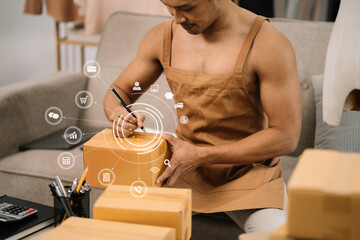 Portrait young attractive asian male owner startup business work happy with box at home prepare...