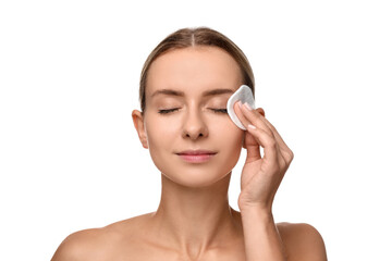 Beautiful woman removing makeup with cotton pad on white background