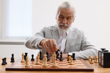 Man playing chess during tournament at table indoors
