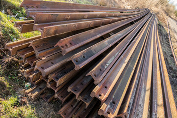 stacked steel rails prepared for the installation of a new railway line