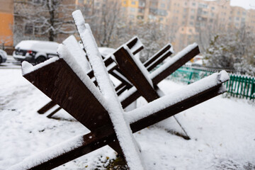 anti-tank barrage on the snow in the winter Kiev city street.