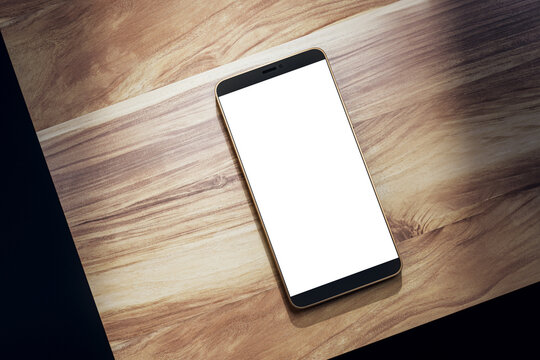 Top view of empty white smartphone on wooden table. Mock up, 3D Rendering.