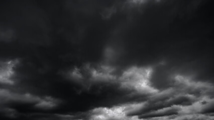 dark dramatic sky with black stormy clouds before rain or snow as abstract background, extreme...