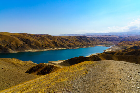 A deserted part of the Zaamin nature reserve in Uzbukistan on a sunny summer day. View of the mountains and reservoir.