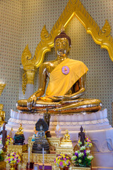 Golden statue of Buddha with a saffron robe and shrine, Wat Songkhram, Bangkok, Thailand