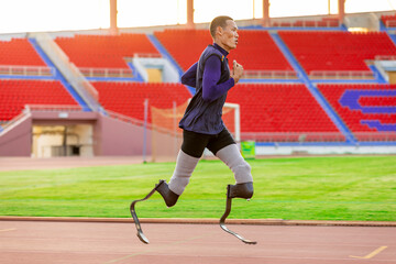 Asian para-athlete with prosthetic blades leg in stadium practicing workout for Paralympic running competition. Amputee sportsman runner practicing running workout. Disabled athlete man sport concept.