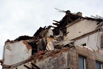 A house destroyed by a missile strike with broken walls and ceiling