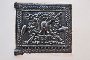 Vintage cast-iron furnace door, plot is Military Fittings.