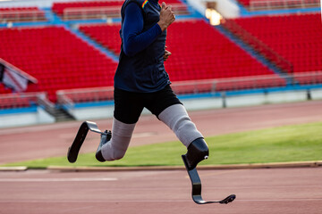 Asian para-athlete with prosthetic blades leg in stadium practicing workout for Paralympic running competition. Amputee sportsman runner practicing running workout. Disabled athlete man sport concept.