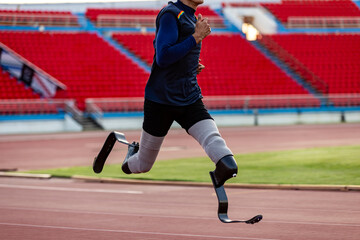 Asian para-athlete with prosthetic blades leg in stadium practicing workout for Paralympic running...