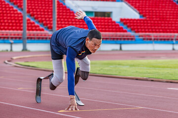 Asian para-athlete with prosthetic blades leg in stadium practicing workout for Paralympic running...