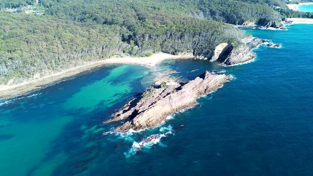 Drone aerial pan landscape bushland rocky cliffs headland snorkel spot swimming diving Guerilla Bay Batemans Bay South Coast Narooma NSW travel tourism 4K Australia