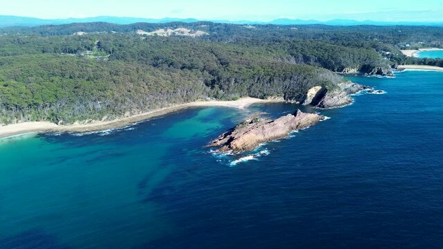 Drone aerial pan ocean sea rock headland snorkel bushland beach swimming diving spot Guerilla Bay Batemans Bay NSW South Coast travel tourism Australia 4K