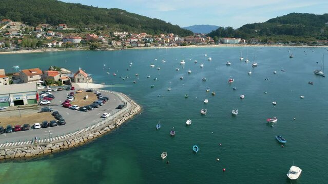 Ascending drone footage of moored boats at the sea in the fishing port of Aldan in Pontevedra, Spain