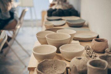 Pottery tablewares on shelves of small art shop.