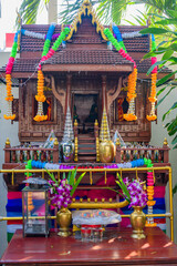 Buddhist shrine outside a car park, Bangkok, Thailand