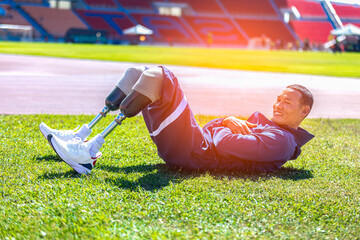 Asian para-athlete with prosthetic blades leg in stadium practicing workout for Paralympic running competition. Amputee sportsman runner practicing running workout. Disabled athlete man sport concept.