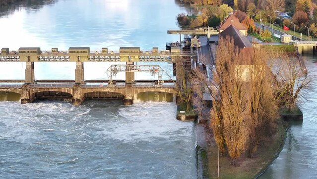 Rhine river high water level at hydroelectric power plant Augst Switzerland, drone back truck 4k