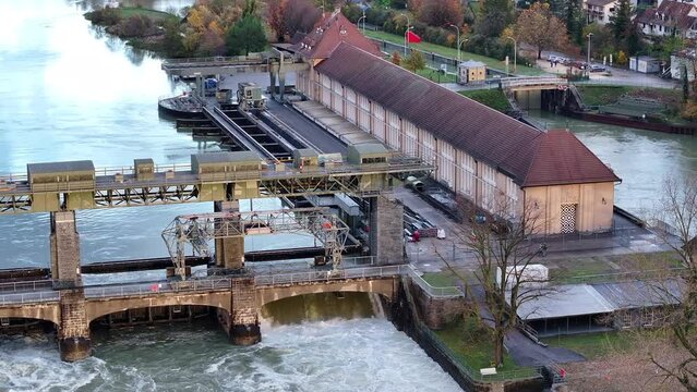 Rhine river high water level at hydroelectric power plant Augst Switzerland, drone pan 4k