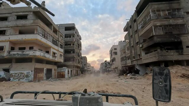 Israeli Humvee forward patrol advance through a built-up area after rocket attacks