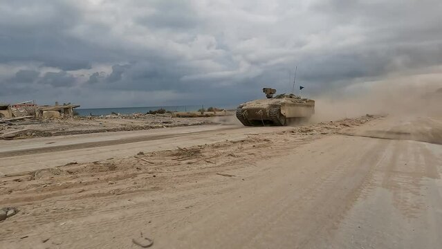Israeli Namer APC speeds along the Mediterranean coastline in the Gaza strip