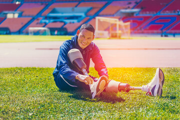Asian para-athlete with prosthetic blades leg in stadium practicing workout for Paralympic running competition. Amputee sportsman runner practicing running workout. Disabled athlete man sport concept.