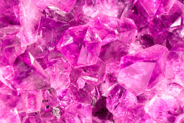 Amethyst pink crystals. Gems. Mineral crystals in the natural environment. Texture of precious and semiprecious stones. Seamless background with copy space colored shiny surface of precious stones.