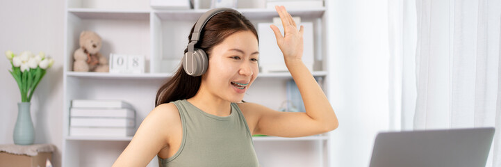 Naklejka premium Woman student chatting or exchanging knowledge through laptop video call, Education through wireless education system, Online learning, Study at your own home.
