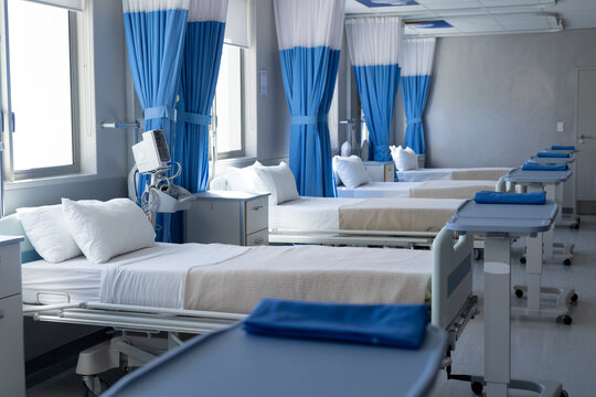 Close up of row of beds in sunny hospital room