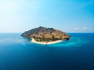 Beautiful small tropical island in the blue ocean, Komodo Indonesia, panoramic aerial drone shot