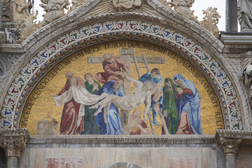Mosaic of Jesus being taken from a cross on facade of Basilica di San Marco. Venice - 5 May, 2019
