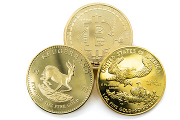 Krugerrand, United States gold eagle 50 dollar coin, and a bitcoin.