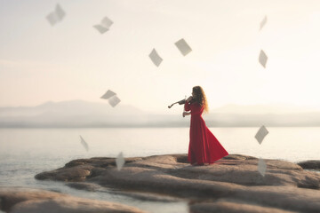 surreal moment of sheet music dancing in the sky in time to the violin music of a woman in red playing