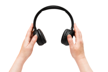 Hands holding big black headphones on isolated transparent background. Png. View from above.
